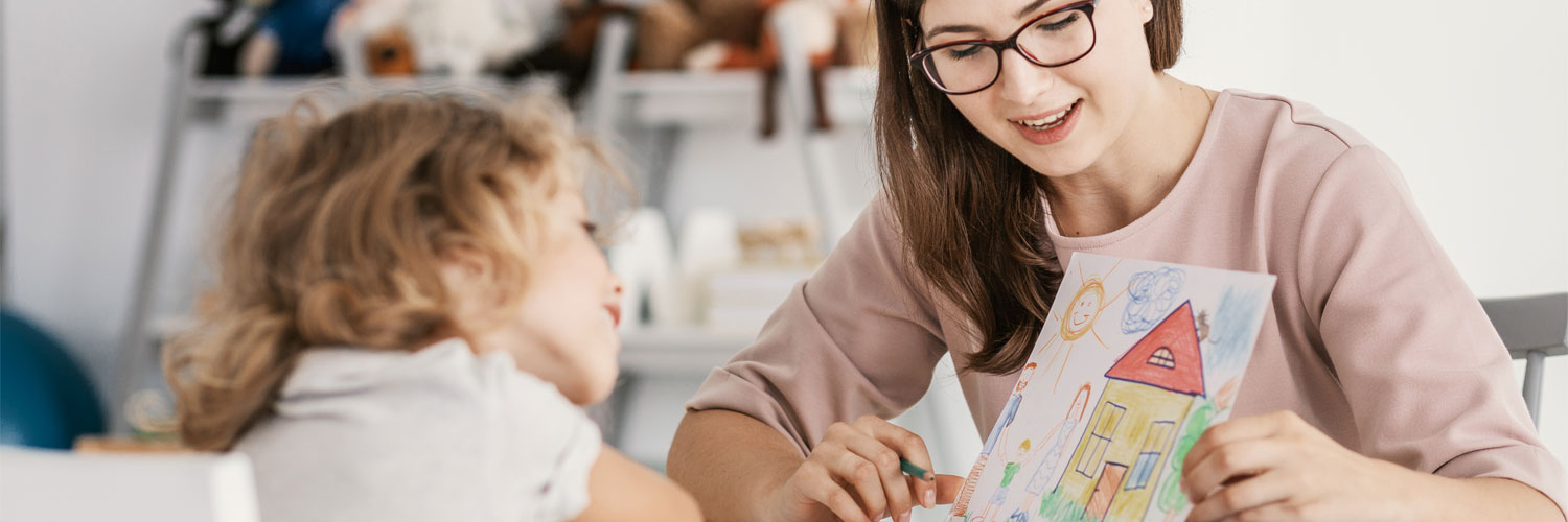 woman and child looking at drawn picture