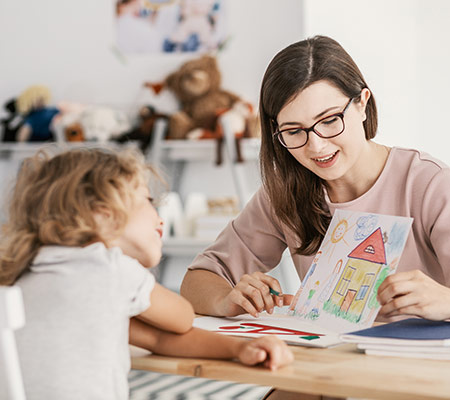 woman and child looking at drawn picture